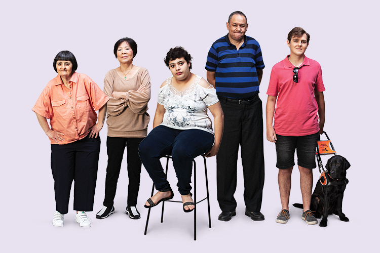The image shows five people. They have visible and invisible disability. One person is sitting down. Another person has a guide dog. They are positioned in a line. 