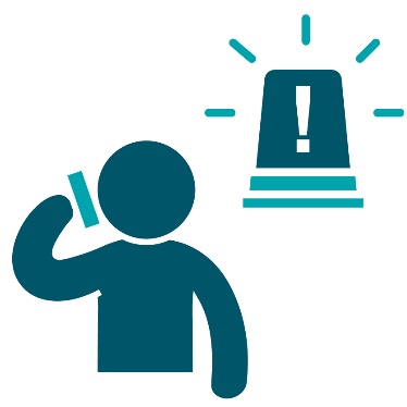 An emergency siren next to a person using a phone.