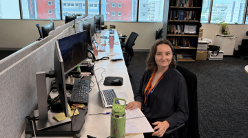 Kaitlyn from YouthWorX NT sitting at her office desk.