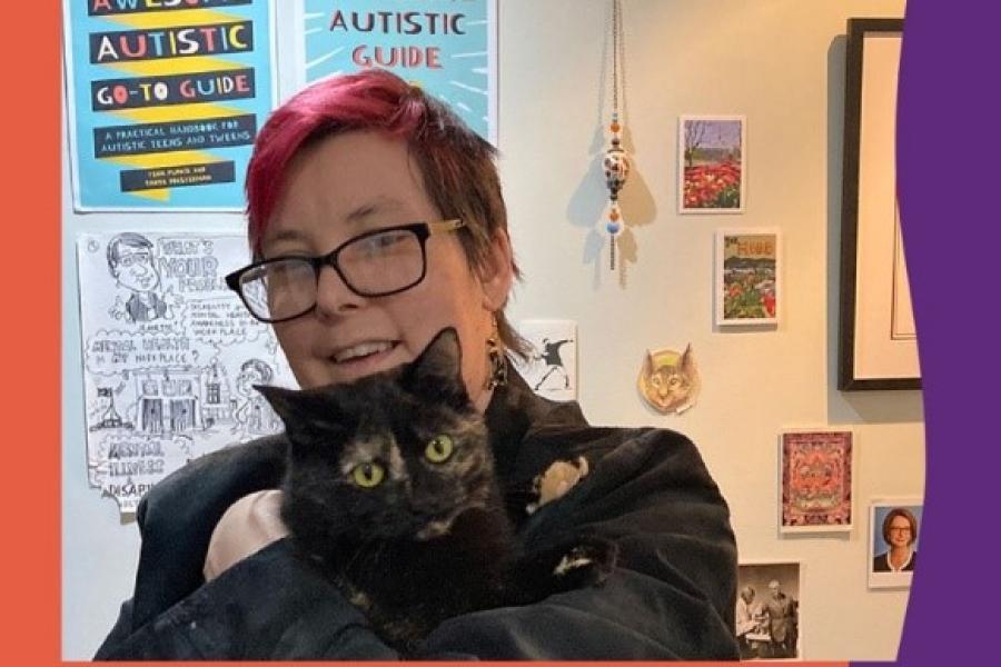 A person holding a black cat in front of a wall decorated in Awesome Autistic Guide posters.