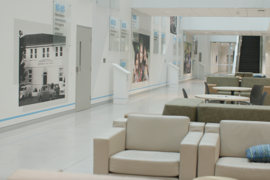 Breakout space with tables and chairs inside building.